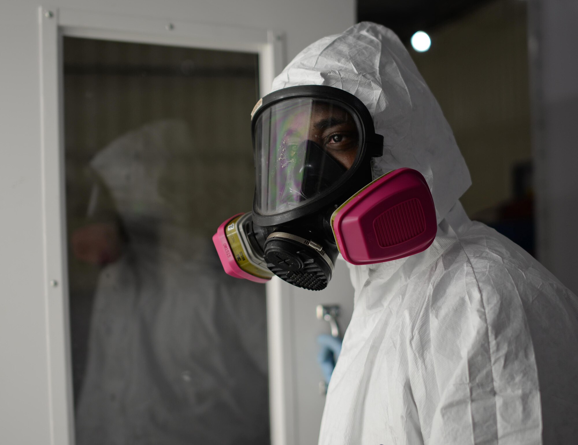 Remediation professional wearing a protective suit and respirator
